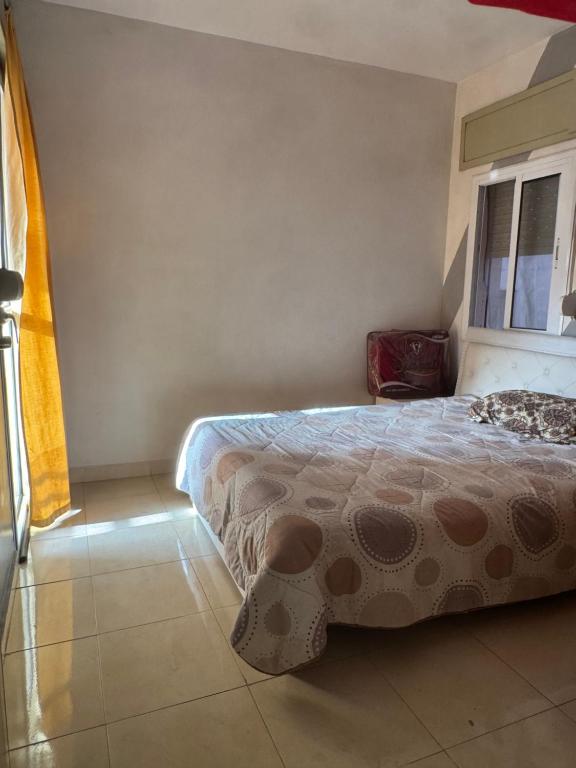 a bedroom with a bed and a window at Perfect Stay Apartment 10 min to airport ibn battouta and beach in Tangier