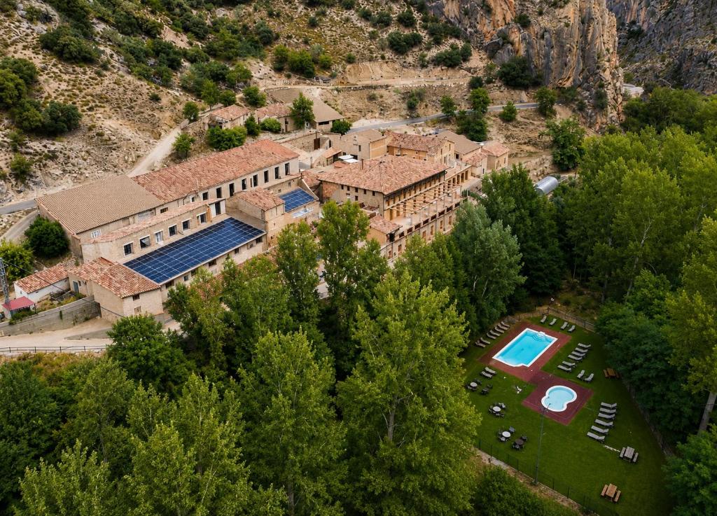an aerial view of a house with a swimming pool at Hotel de La Trucha in Villarluengo