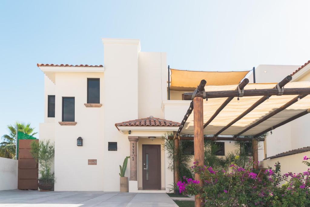 a white house with a wooden pergola at Outsite Los Cabos - Entire 4-Bedroom Home in San José del Cabo