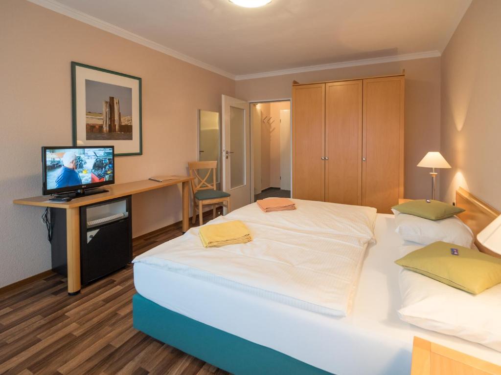 Postel nebo postele na pokoji v ubytování Hotel Spiekeroog