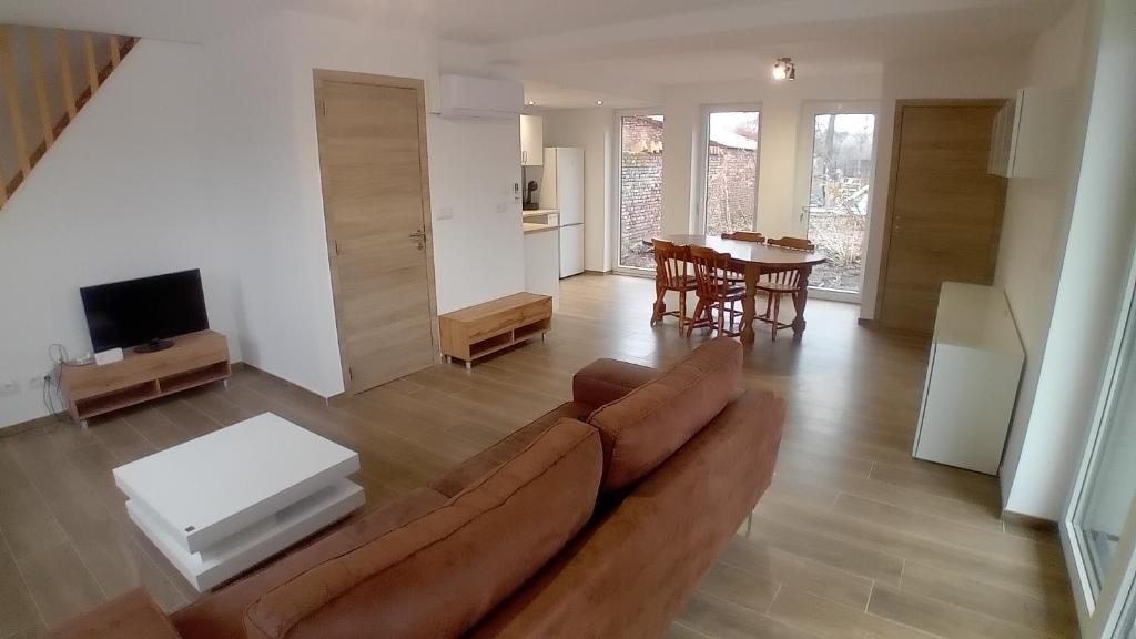 a living room with a couch and a table at L'entracte in Hensies