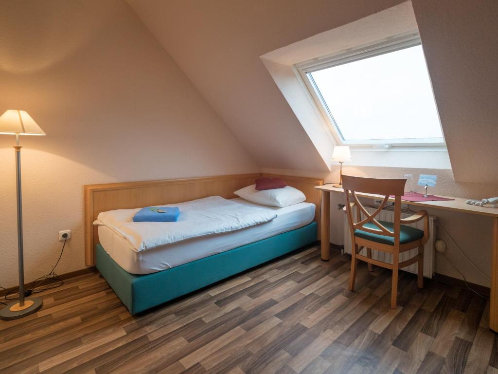 Postel nebo postele na pokoji v ubytování Hotel Spiekeroog