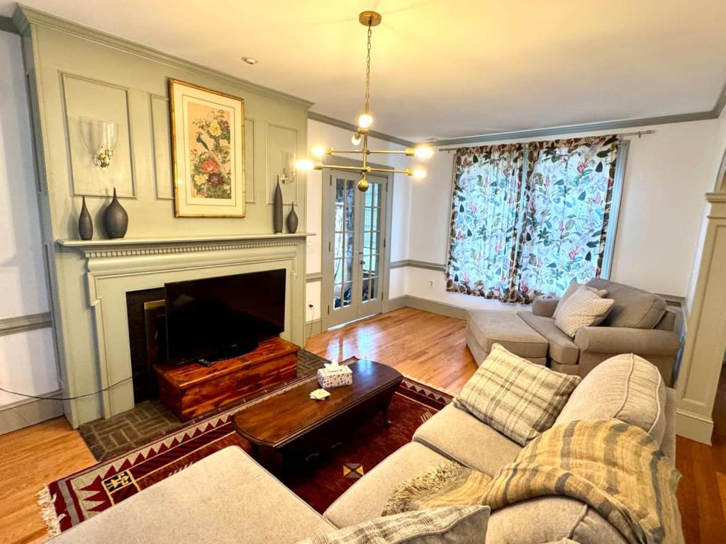 a living room with a couch and a fireplace at Camden at Monticello in Salisbury