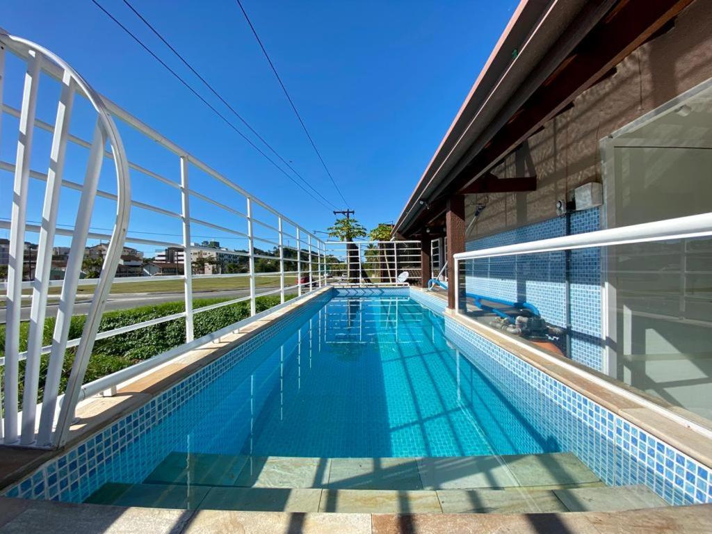 a swimming pool on top of a building at Pousada Werneck Residence Suites in Ubatuba