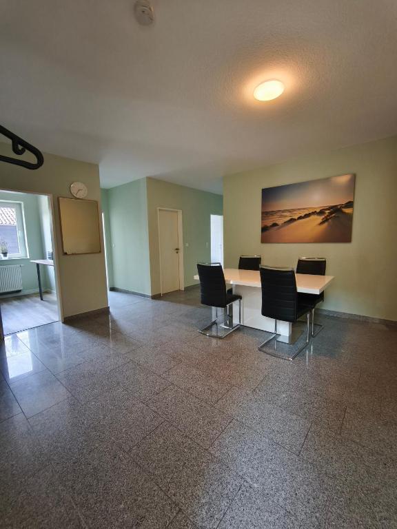 an empty room with a table and chairs in it at Fewo Gloria in Altenbeken