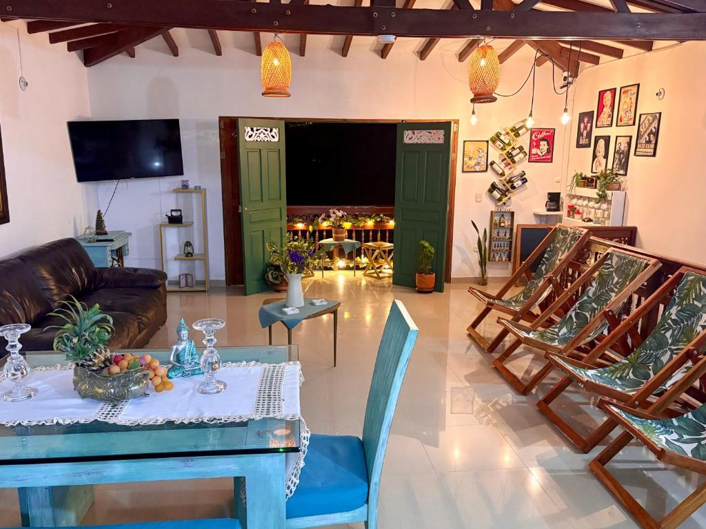 a living room with a table and chairs at Blomst Casa Hostal in Jericó