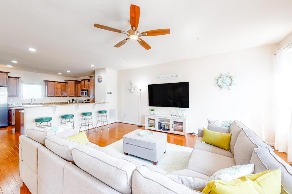 a living room with a white couch and a ceiling fan at Seaside Village --- #3 in Ocean City