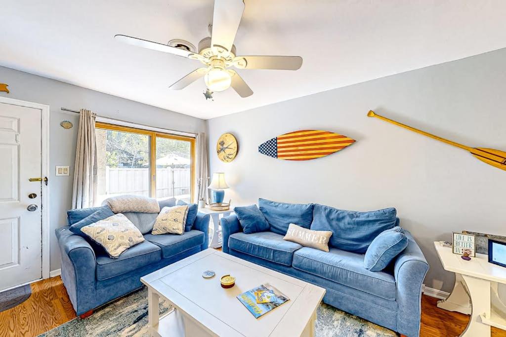 a living room with two blue couches and a table at Whispering Woods #26 in Ocean City