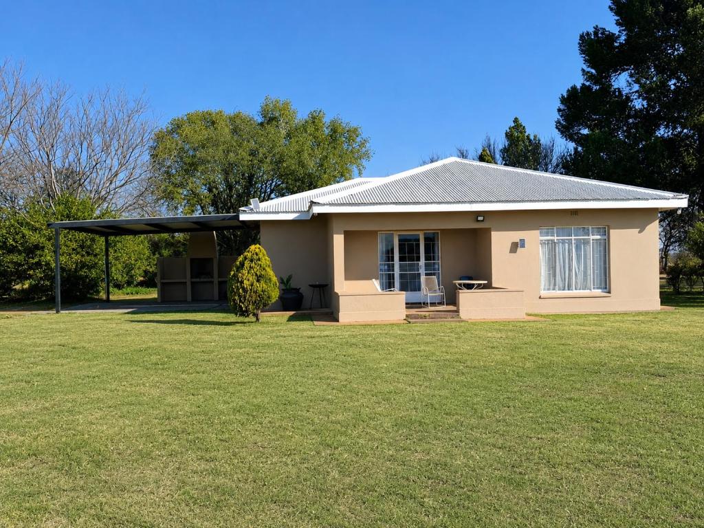 a small house with a large grass yard at Nawi Unit 3 in Potchefstroom