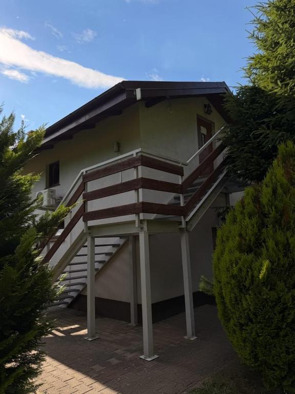 a house with a staircase on the side of it at Apartament ADA in Niesulice