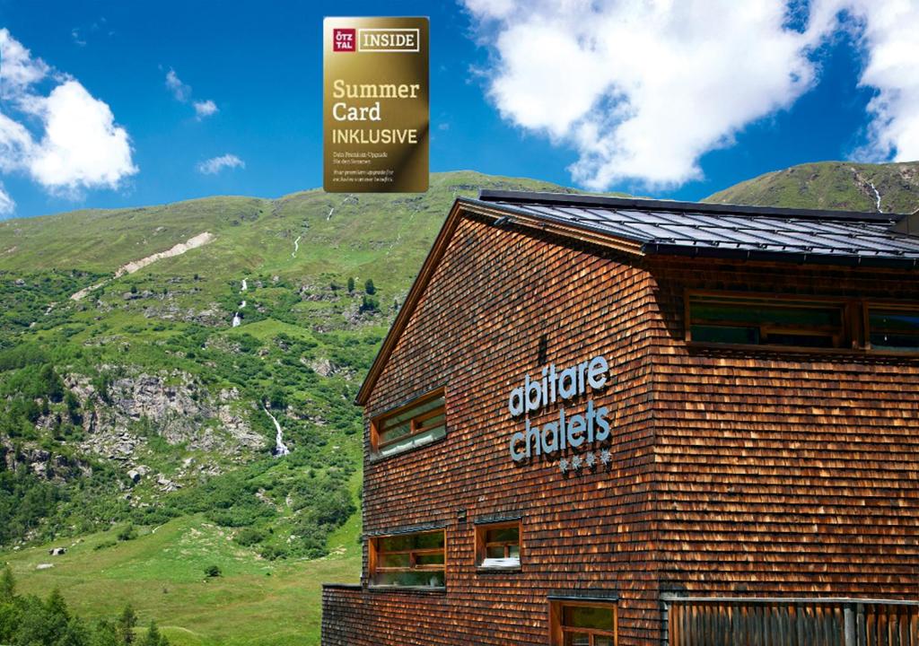 a sign on the side of a building next to a mountain at abitare chalets in Obergurgl
