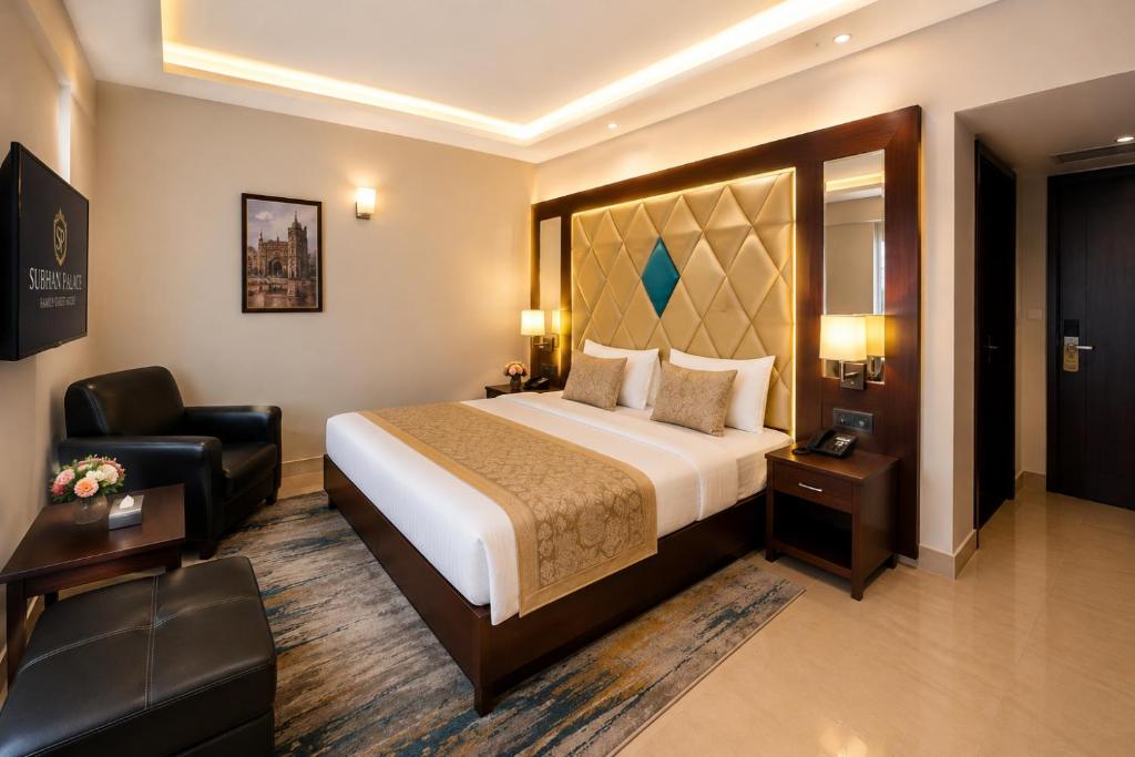 a hotel room with a bed and a chair at Subhan Palace Guest House in Karachi