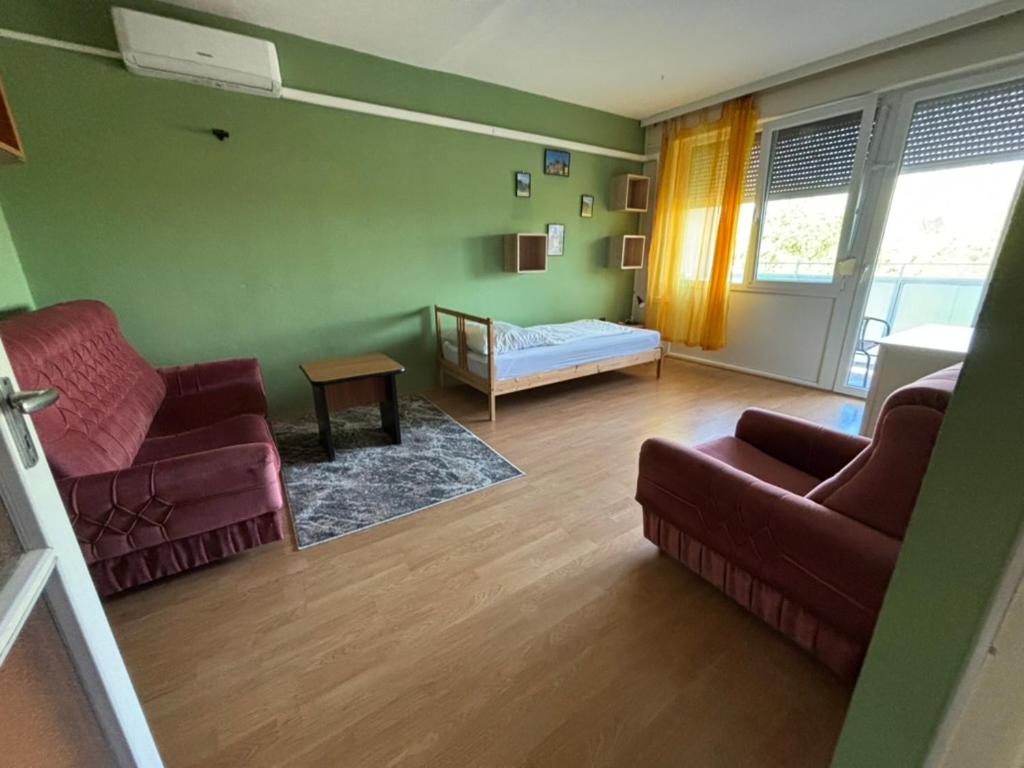 a living room with two couches and a couch at Piszkei Apartman in Lábatlan