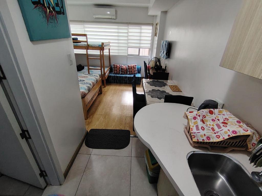 a room with a sink and a room with a bed at Tala Transient House in Baguio