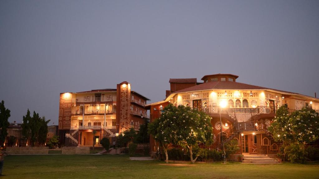 a large building with lights on it at night at Nirali Dhani Ethnic Resort in Jodhpur