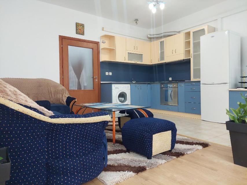 a kitchen with a couch and a table and a refrigerator at Hristean Apartment Petrich in Petrich