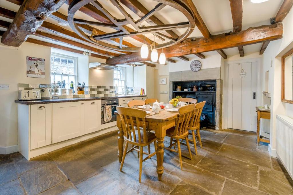 a kitchen with a wooden table and chairs at 2 Bed in Askrigg oc-ds778 in Askrigg