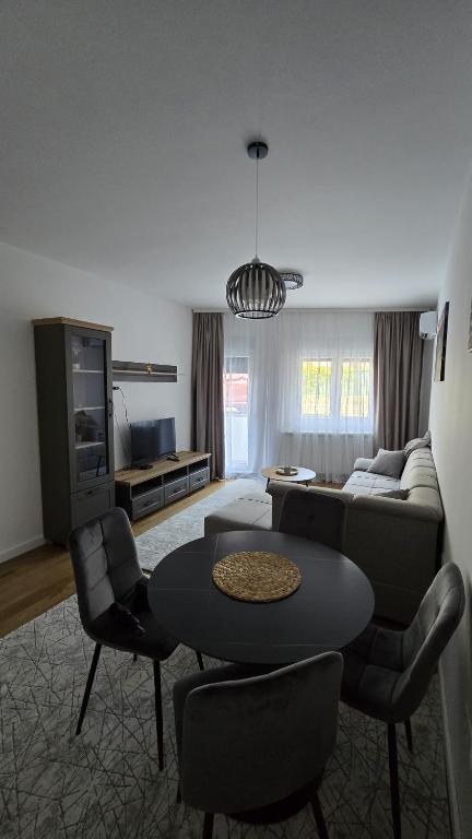 a living room with a couch and a table and chairs at Vozd Apartment in Belgrade