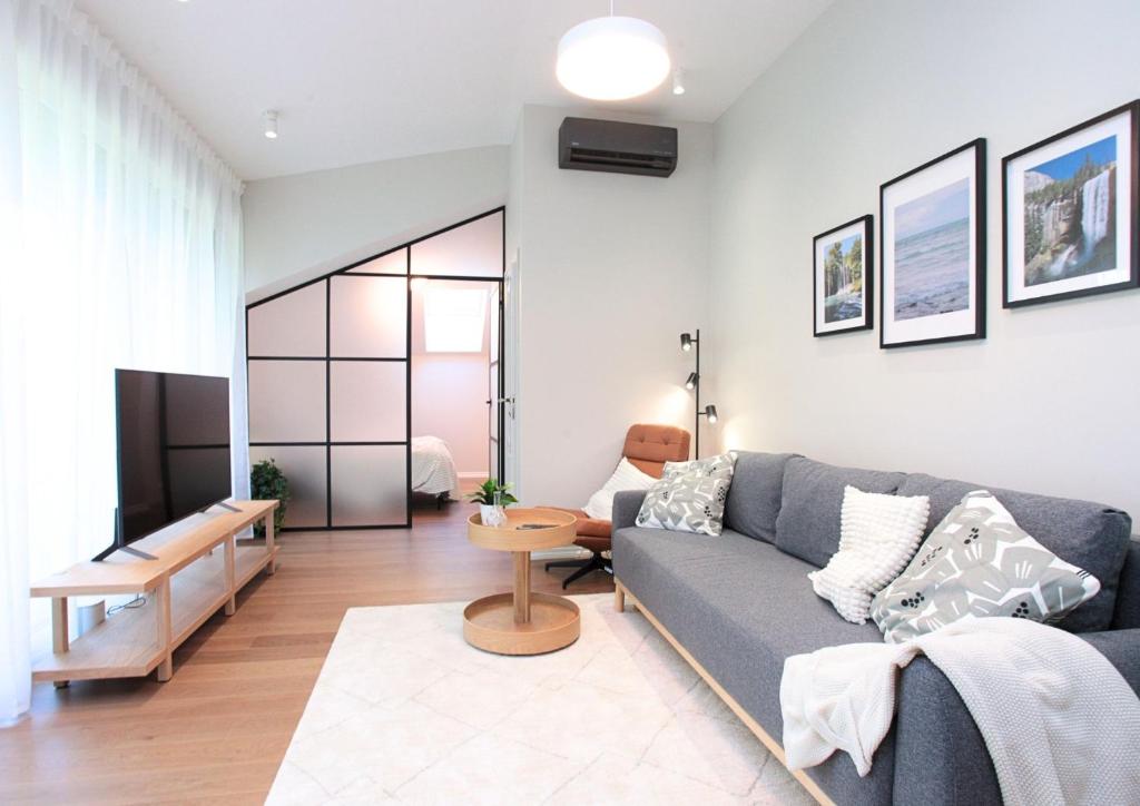 a living room with a couch and a table at Otepää Residence in Otepää