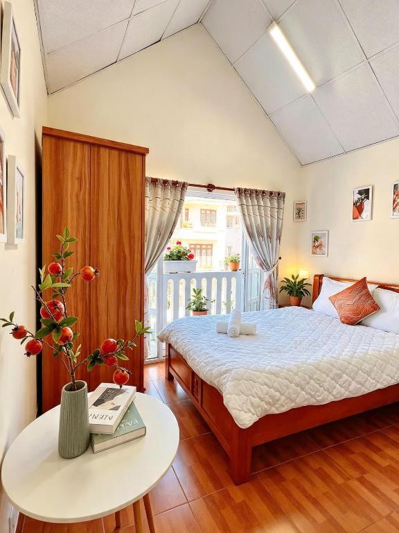 a bedroom with a large bed and a table at Mie House Da Lat in Xuan An