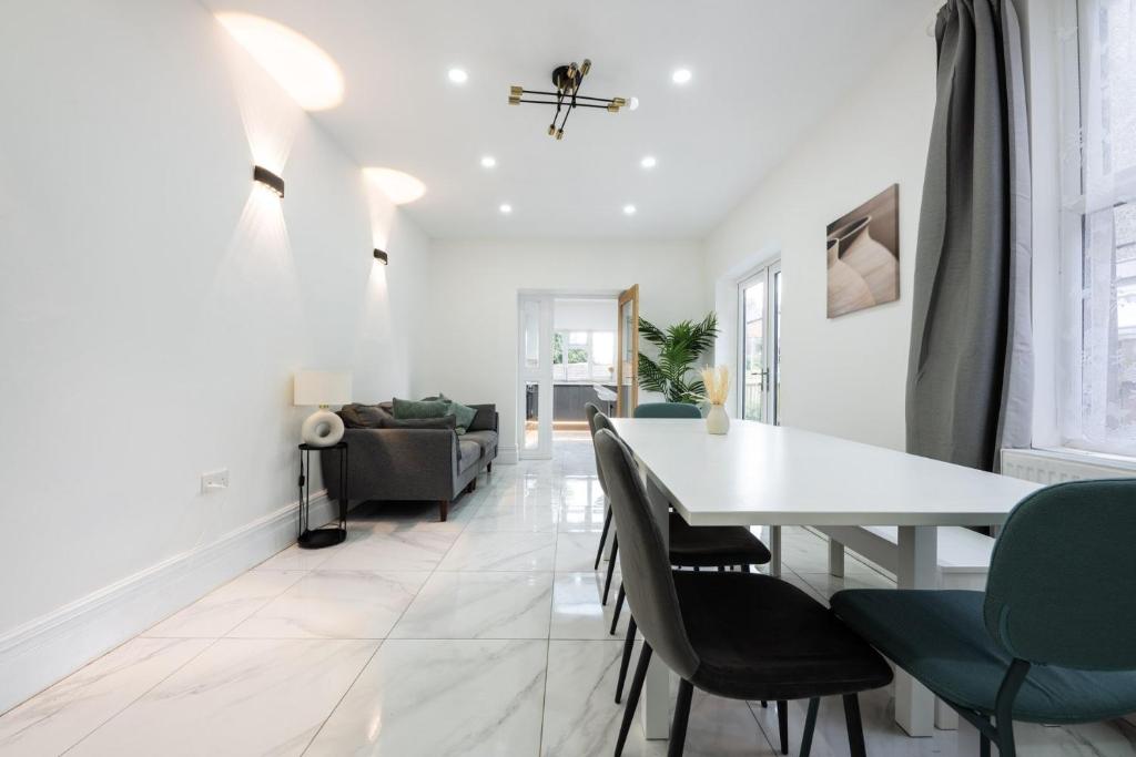 a dining room and living room with a table and chairs at Spacious 6BR Cardiff House w/ Free Parking in Cardiff