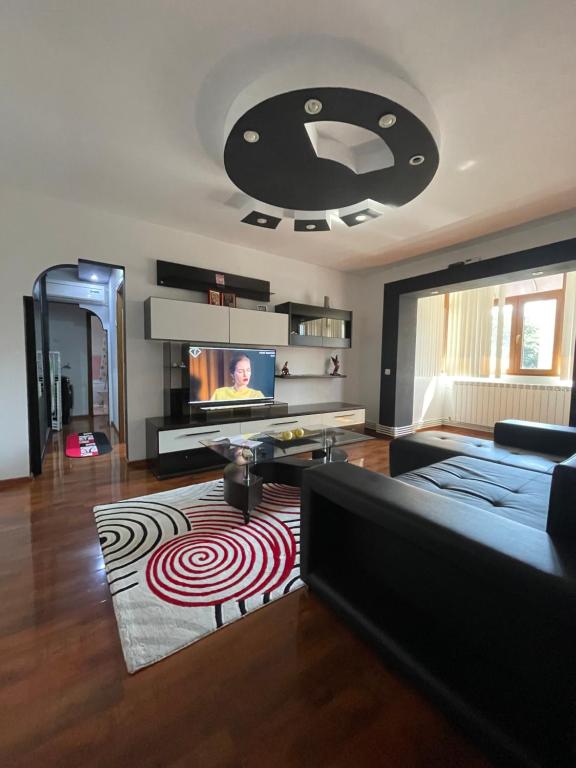 a living room with a couch and a flat screen tv at Cosy Home Apartament in Craiova