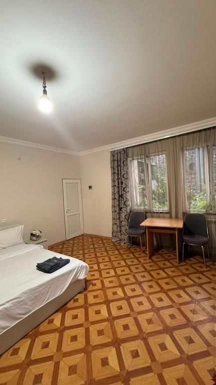 a bedroom with a bed and a table and chairs at Joni Mot in Goris