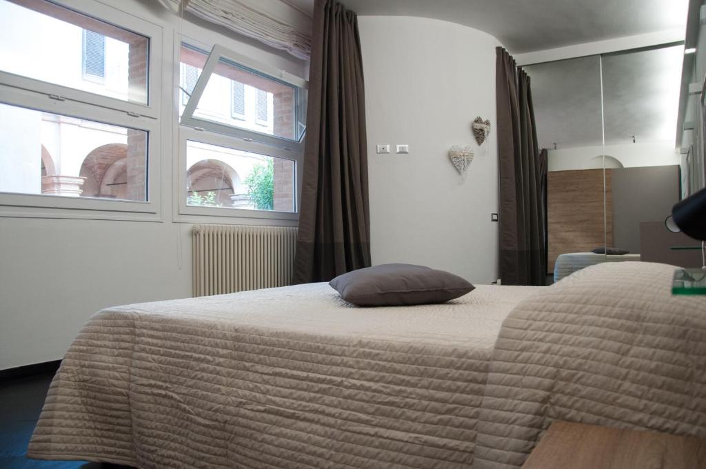 a bedroom with a bed with a pillow on it at 29 by Le Suite in Lugo