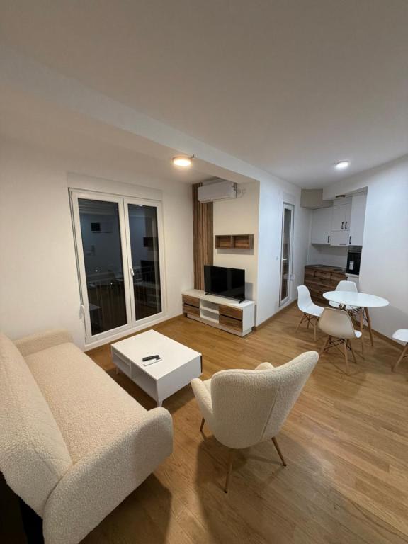 a living room with a couch and chairs and a table at Božur 2 in Vrnjci