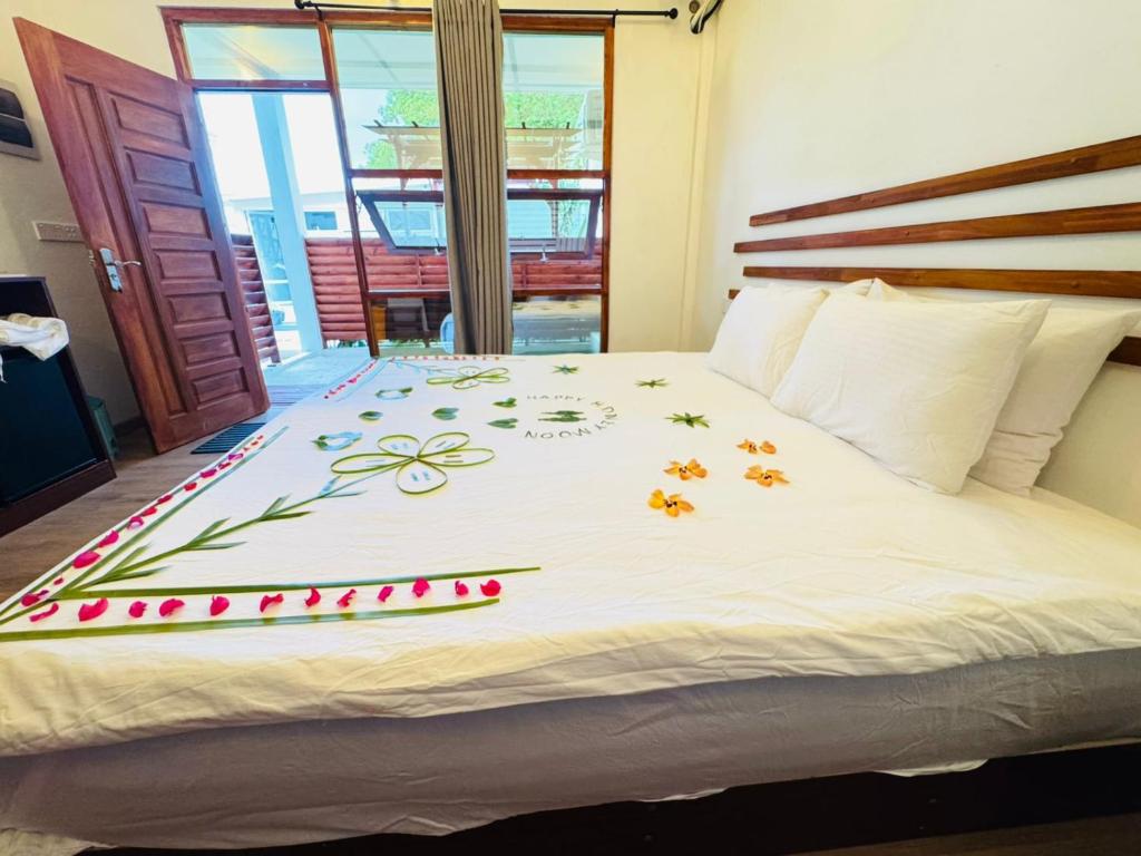 a bedroom with a bed with flowers on it at Sevenseas Seaview Maldives in Feridhoo