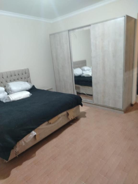 a bedroom with a large bed and a mirror at العبور الحى التاسع in Obour