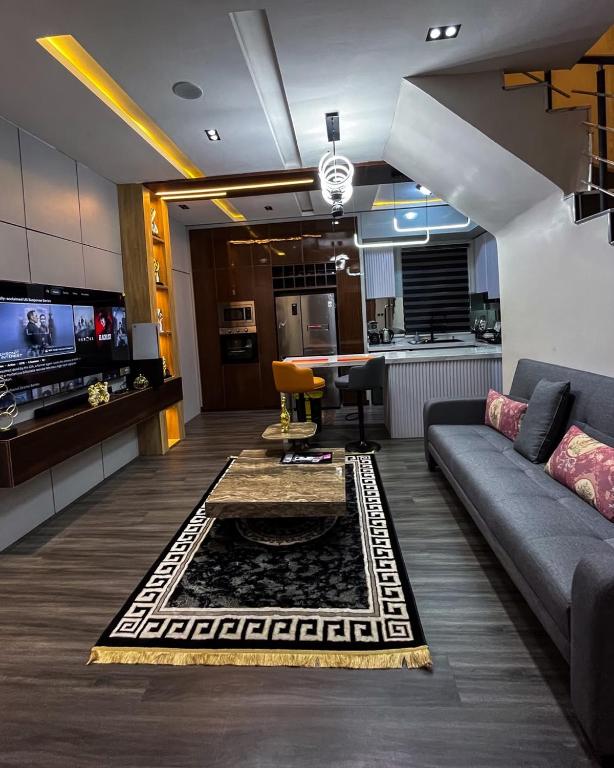 a living room with a couch and a kitchen at Didi's Apartment in Lekki