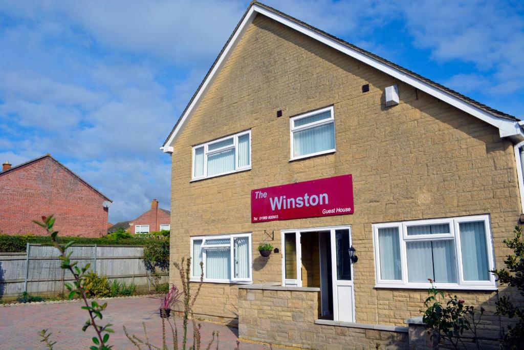 a house with a sign that reads the mutation at Winston Guesthouse in Bicester