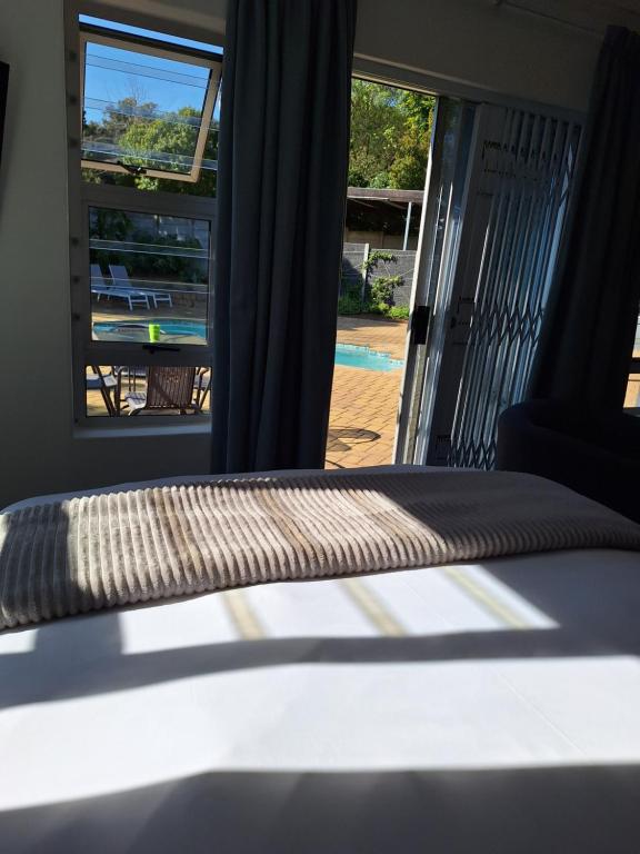 a bed in a room with a sliding glass door at Dee-One's at Napier in Kenridge