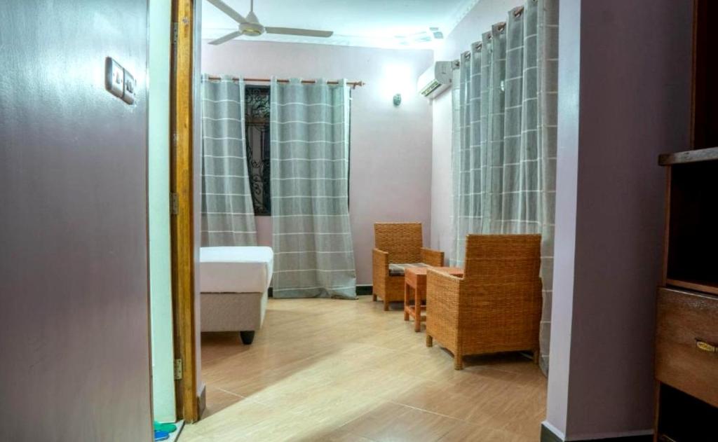 a bathroom with a shower and a sink and a table at Paradiso Apartments in Dar es Salaam