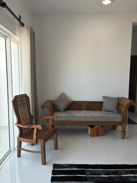 a couch and a chair in a living room at Bay Nest in Wellawatta