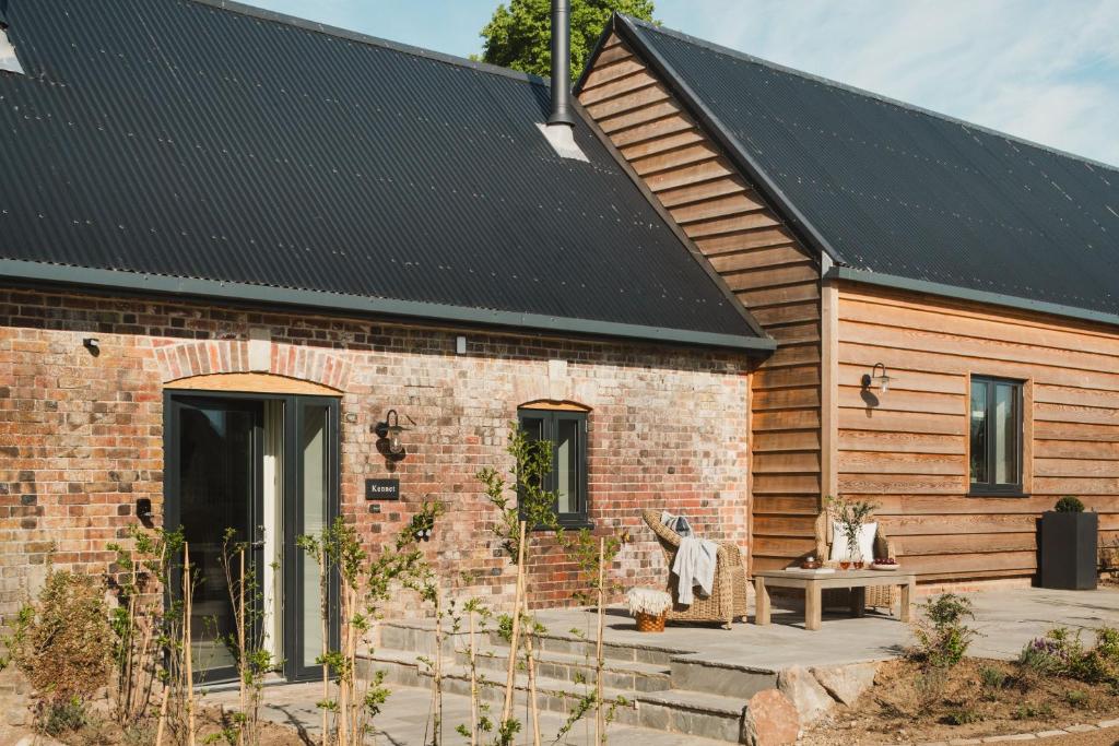 a brick house with a black roof at Kennet in Marlborough