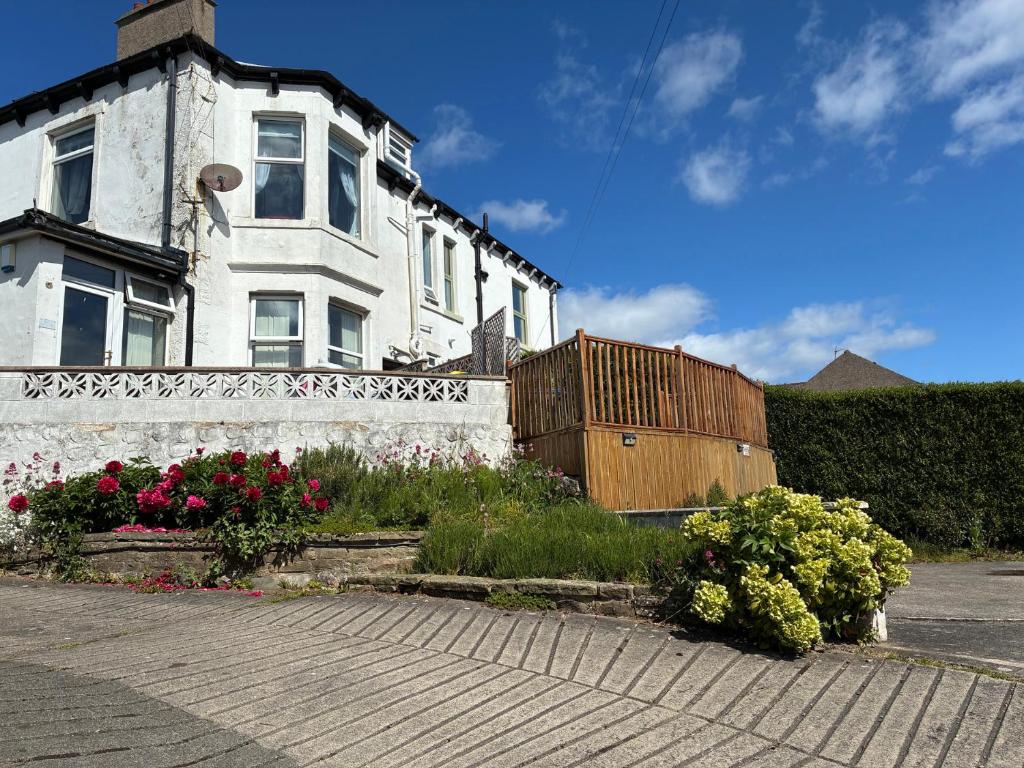 a white house with flowers in front of it at Ferncliffe in Morecambe