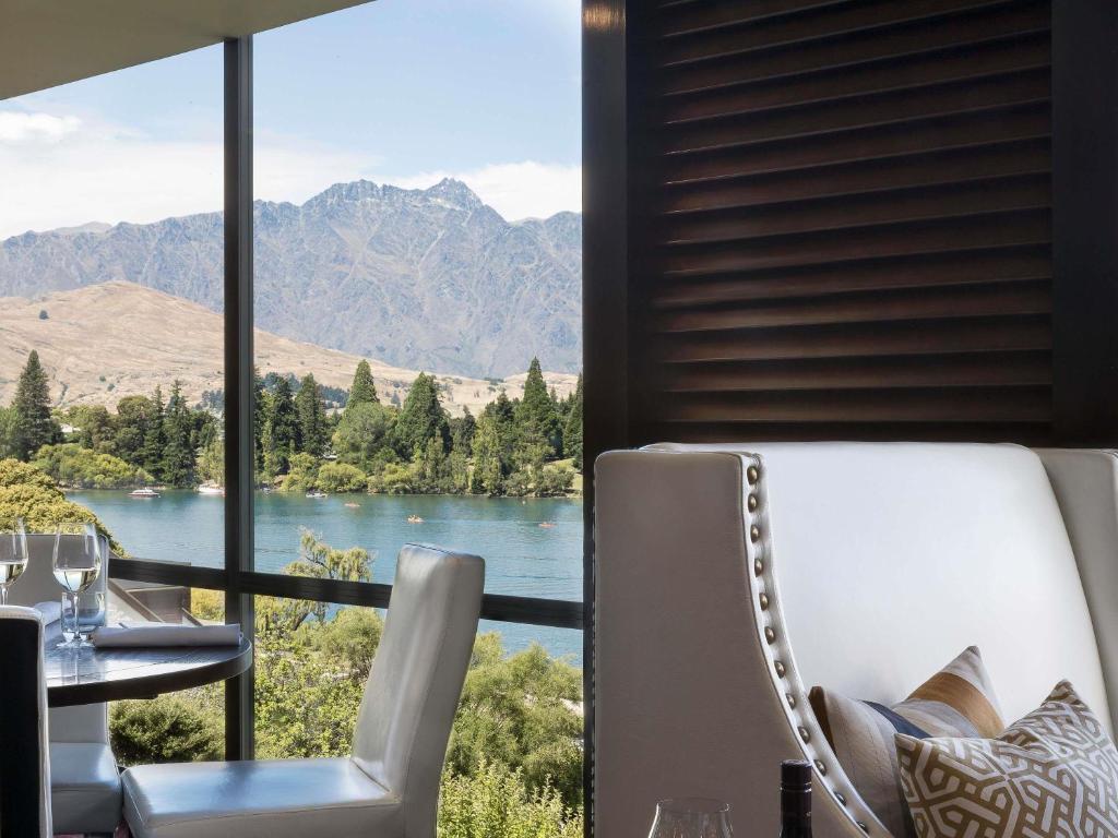 a room with a view of a lake and mountains at Hotel St Moritz, Queenstown - MGallery Collection in Queenstown