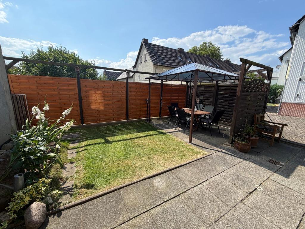 a patio with a table and an umbrella at Haus Milan in Holzminden