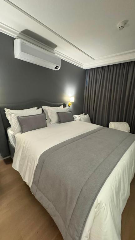 a bedroom with a large white bed in it at Gran Valley Resort in Gramado
