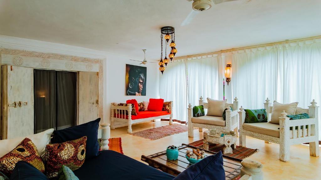 a living room with a blue couch and chairs at Villa Amani in Malindi