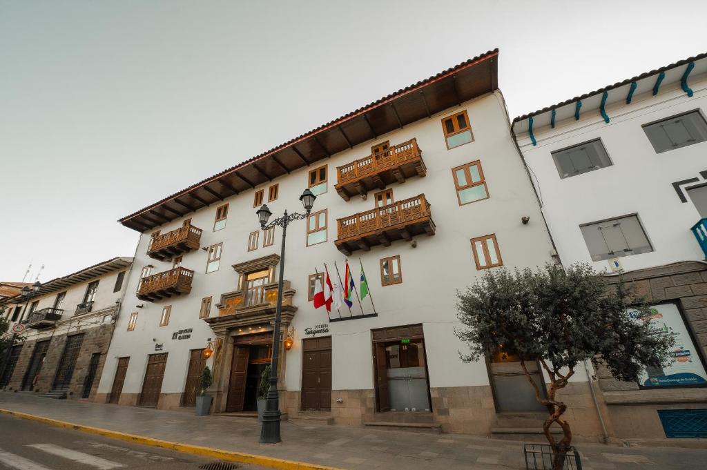 a large white building on the side of a street at San Agustin El Dorado in Cusco