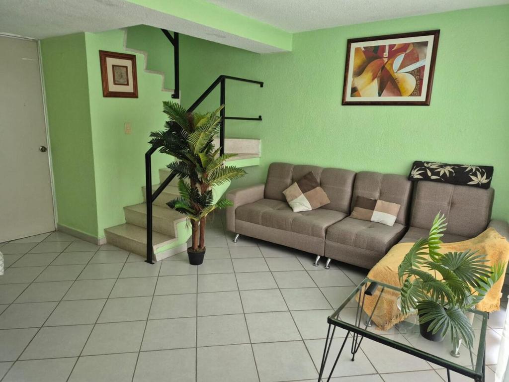 a living room with a couch and a table at Casa de los Sauces in Toluca