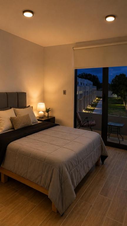 a bedroom with a large bed and a large window at Casa completa de fin de semana Cuautla in Tlayecac