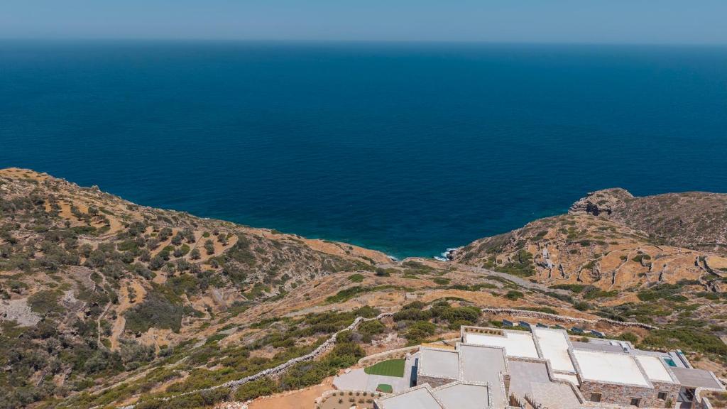 an aerial view of a building on a hill next to the ocean at Vounara Houses in Artemonas
