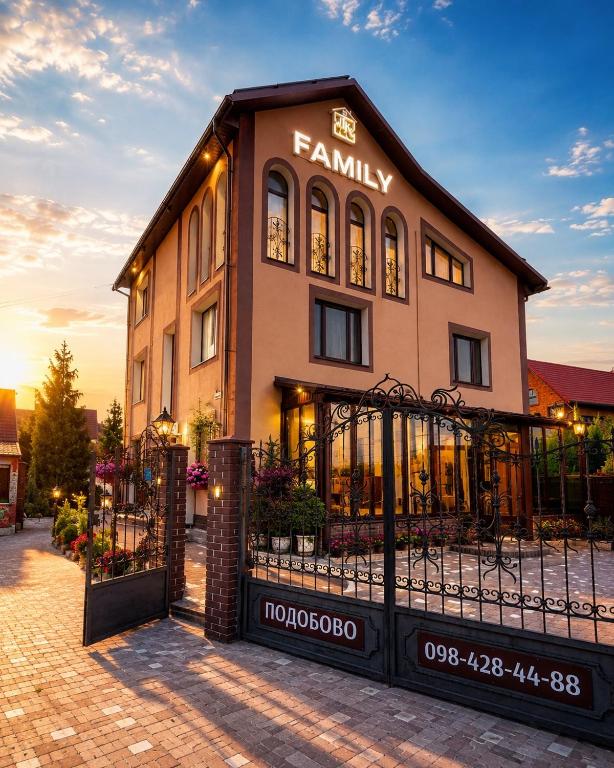 a building with a fence in front of it at Family ЛюКс in Kamianets-Podilskyi