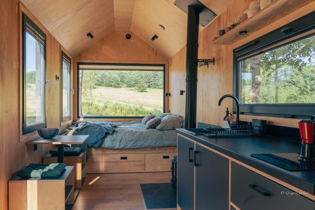 a bedroom in a tiny house with a bed at OtuliLas - Tiny House in Komarno