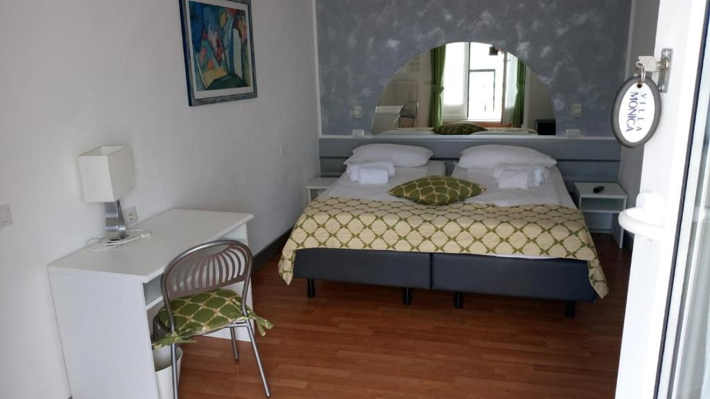 a bedroom with a bed and a mirror at Villa Monica in Malcesine