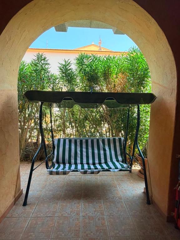 a bench sitting under a table on a patio at La Terrazza sul Golfo in Golfo Aranci